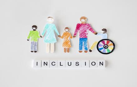 family with disables person cutout paper inclusion concept